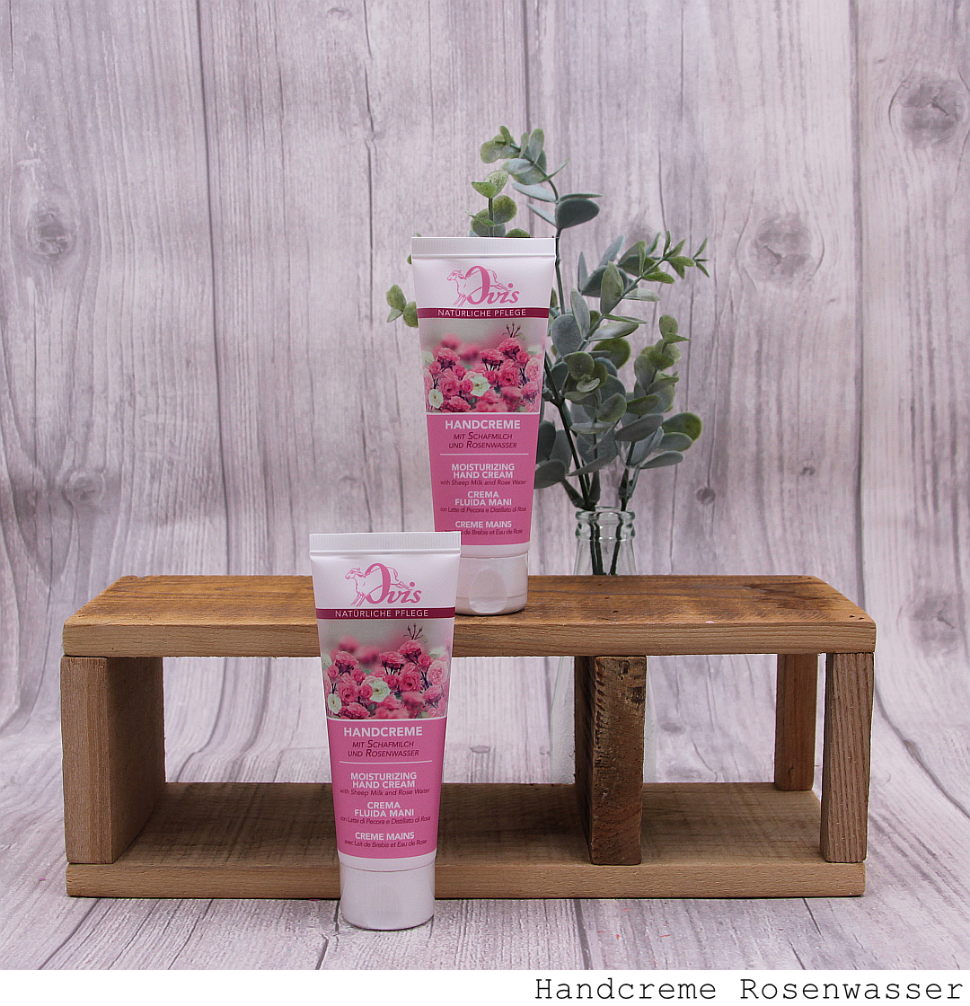 Handcreme in Tube, Rosenwasser, auf und vor Holzregal stehend